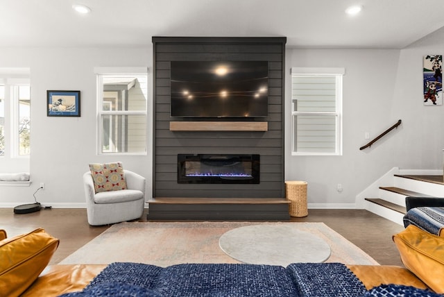 living room with a fireplace and dark hardwood / wood-style floors