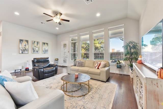 living room featuring lofted ceiling, dark wood-type flooring, and ceiling fan