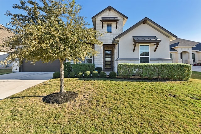 view of front of home featuring a front yard and a garage