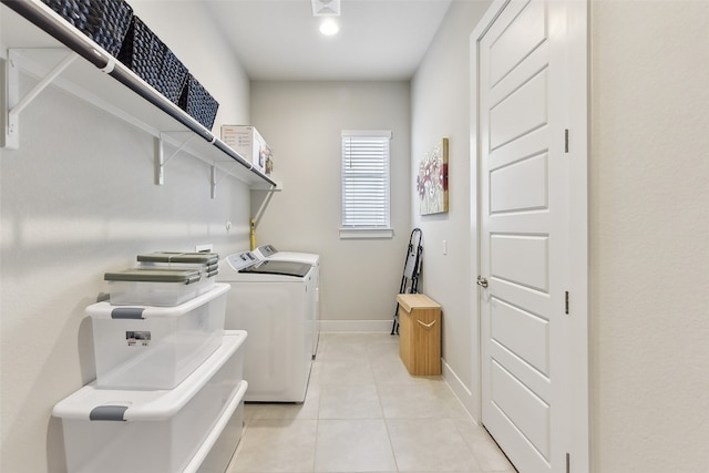 washroom featuring light tile patterned floors and washer and clothes dryer