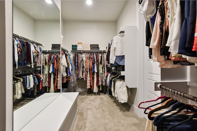 spacious closet featuring light colored carpet