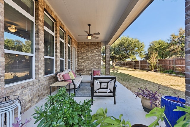 view of patio with an outdoor living space and ceiling fan