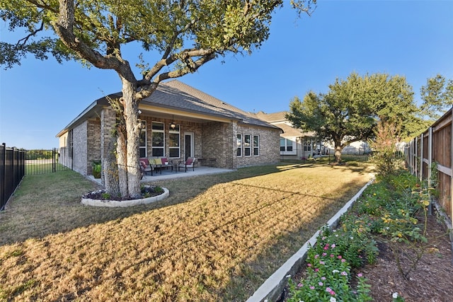 back of property featuring a patio area and a lawn