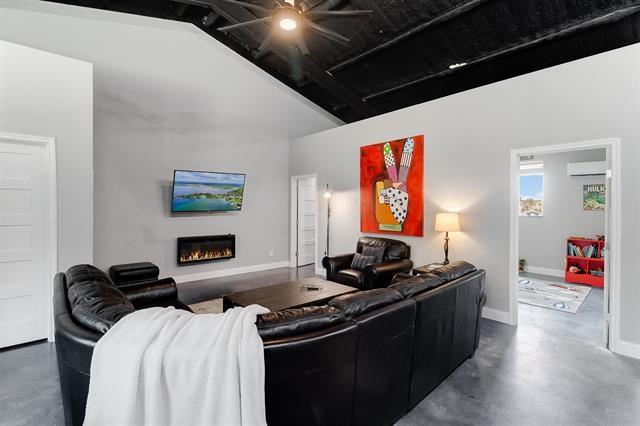 living room with ceiling fan and lofted ceiling