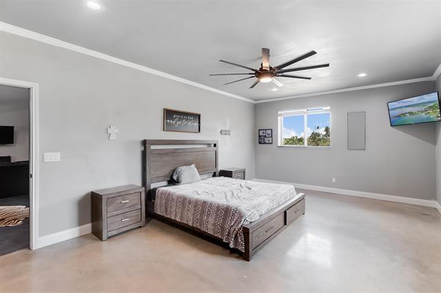 bedroom with ceiling fan and crown molding