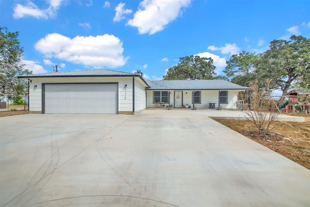 single story home featuring covered porch and a garage