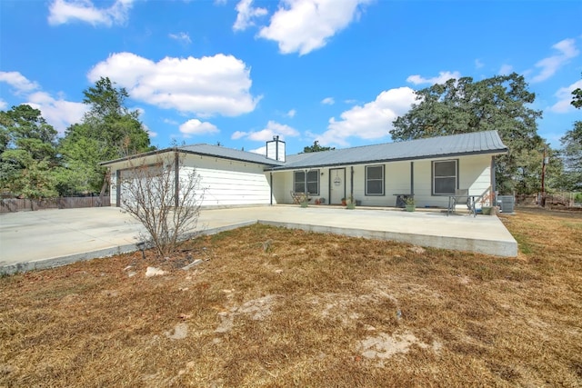 ranch-style home with central AC unit and a garage