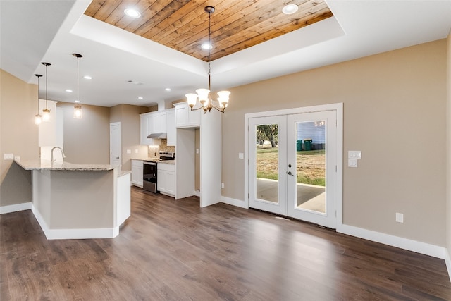 kitchen featuring dark wood-type flooring, white cabinetry, stainless steel range with electric cooktop, and a raised ceiling