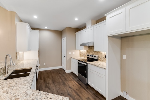 kitchen with sink, light stone countertops, stainless steel range with electric cooktop, white cabinetry, and dark hardwood / wood-style flooring