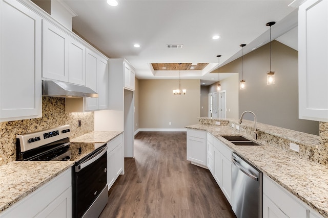 kitchen featuring stainless steel appliances, pendant lighting, white cabinets, range hood, and dark hardwood / wood-style floors