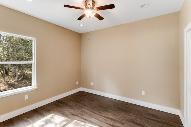 unfurnished room with ceiling fan and dark hardwood / wood-style flooring