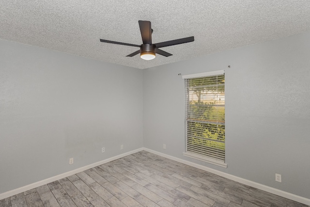 unfurnished room with ceiling fan, a textured ceiling, and light hardwood / wood-style flooring