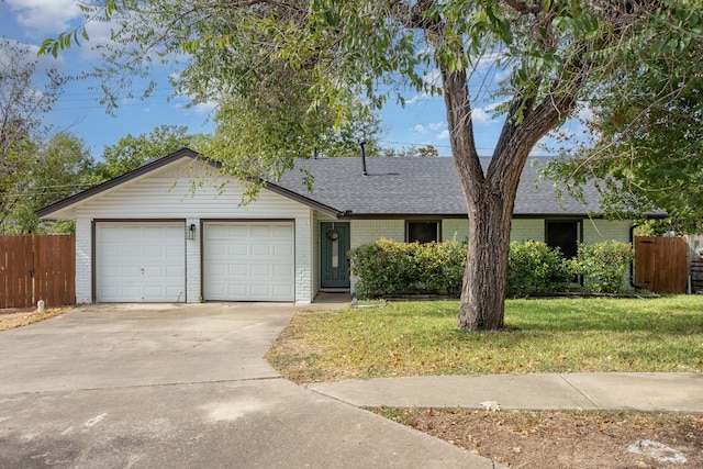 ranch-style home with a front yard and a garage