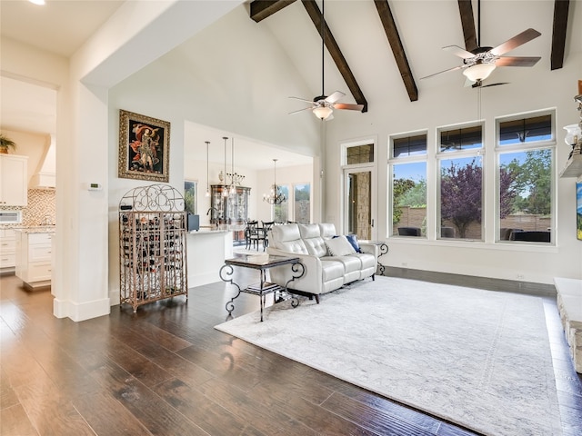 living room featuring dark wood-type flooring, ceiling fan, high vaulted ceiling, and beamed ceiling