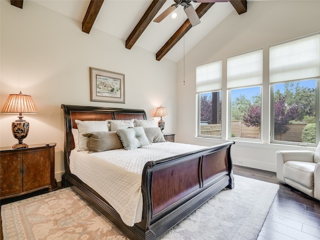 bedroom featuring ceiling fan, wood-type flooring, and vaulted ceiling with beams