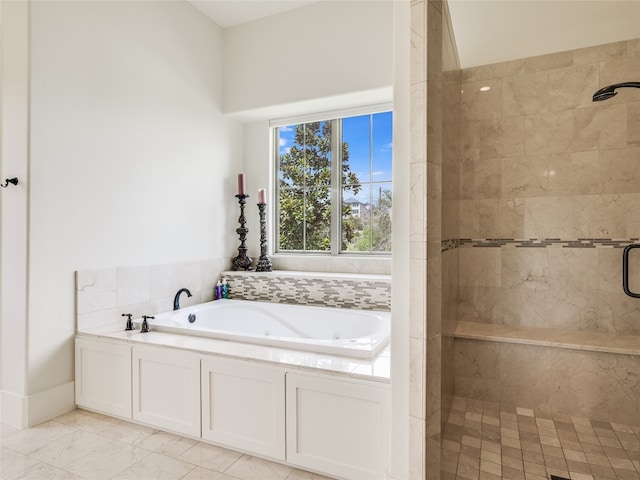 bathroom with separate shower and tub