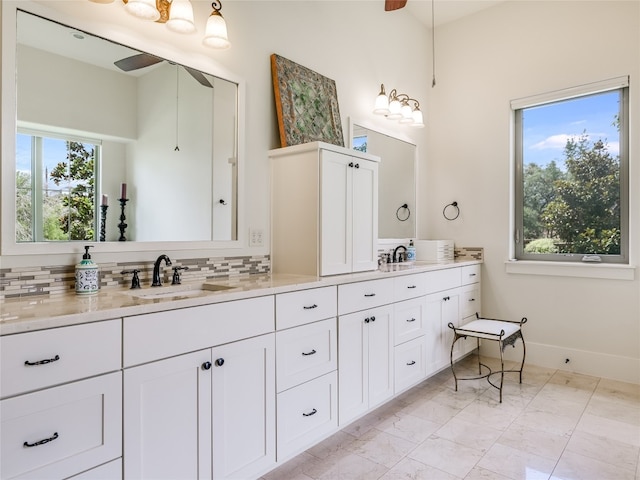 bathroom with vanity, ceiling fan, and backsplash