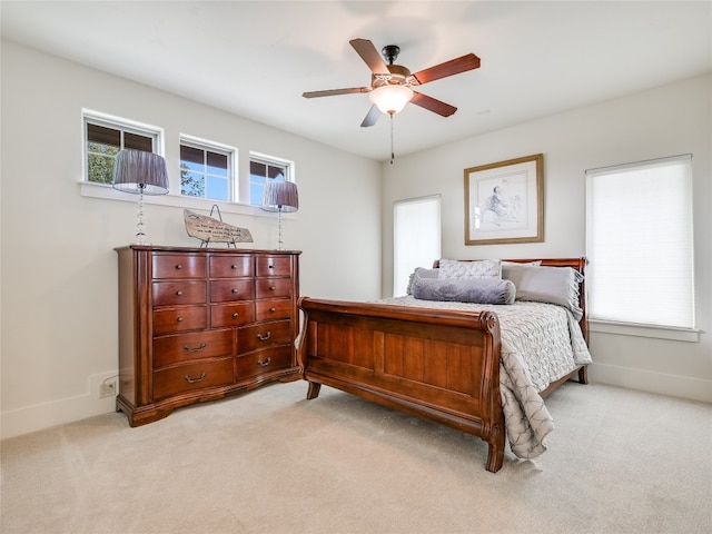 bedroom featuring ceiling fan and light carpet