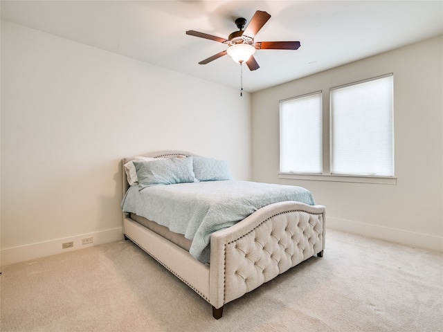 bedroom featuring light carpet and ceiling fan