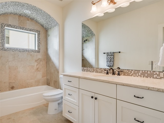 full bathroom with decorative backsplash, toilet, vanity, tiled shower / bath combo, and tile patterned floors