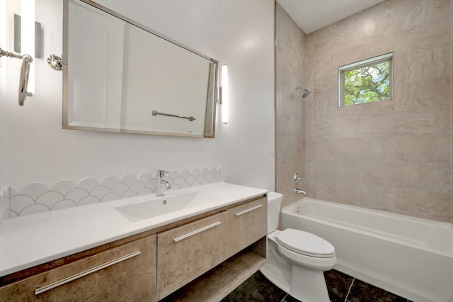 full bathroom featuring vanity, tiled shower / bath, toilet, and tile patterned flooring