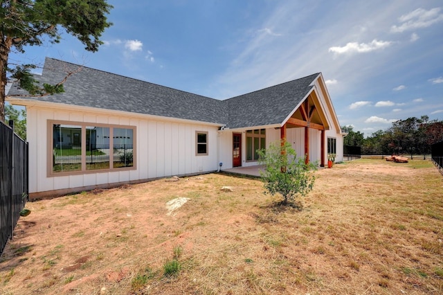 back of house featuring a patio and a lawn