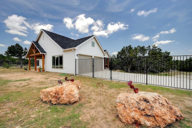 view of side of home with a garage and a lawn