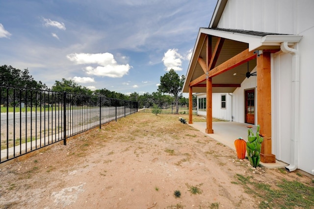 view of yard featuring a patio area and ceiling fan