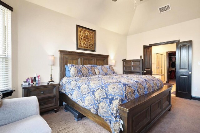 bedroom featuring vaulted ceiling and carpet flooring