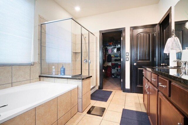 bathroom featuring vanity, a baseboard heating unit, shower with separate bathtub, and tile patterned floors