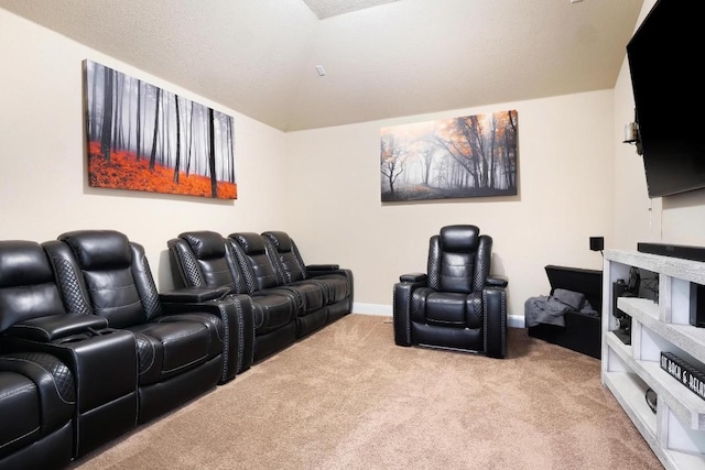 carpeted home theater room with lofted ceiling and baseboards