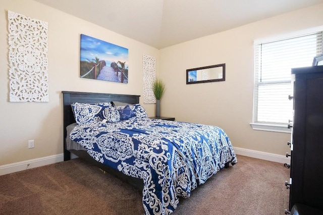 carpeted bedroom featuring baseboards