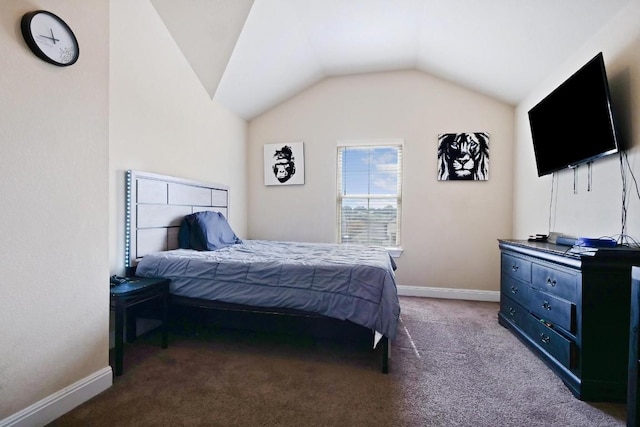 carpeted bedroom with baseboards and vaulted ceiling