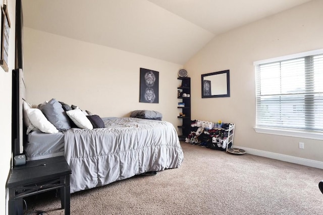 bedroom with baseboards, vaulted ceiling, and carpet flooring