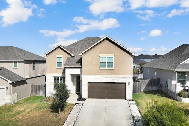 traditional home with concrete driveway, a shingled roof, fence, and stucco siding