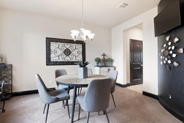 carpeted dining room featuring an inviting chandelier