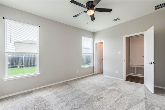 unfurnished bedroom featuring light carpet and ceiling fan