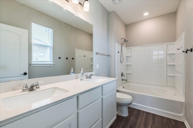 full bathroom featuring vanity, toilet, hardwood / wood-style flooring, and shower / tub combination