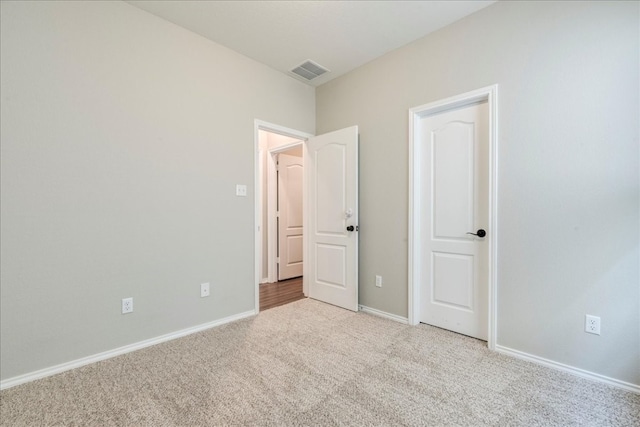 unfurnished bedroom with light carpet