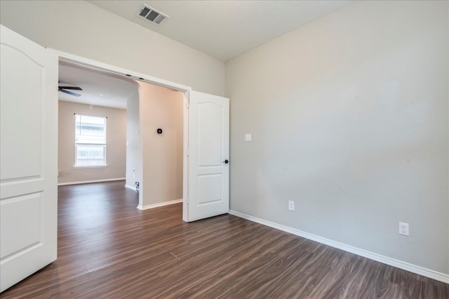 empty room with ceiling fan and dark hardwood / wood-style floors