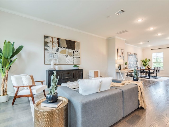 living room featuring hardwood / wood-style floors and crown molding