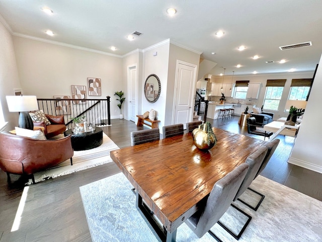 dining space with dark hardwood / wood-style floors and crown molding