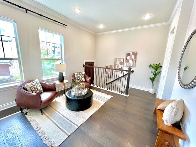 living area with dark hardwood / wood-style flooring and ornamental molding