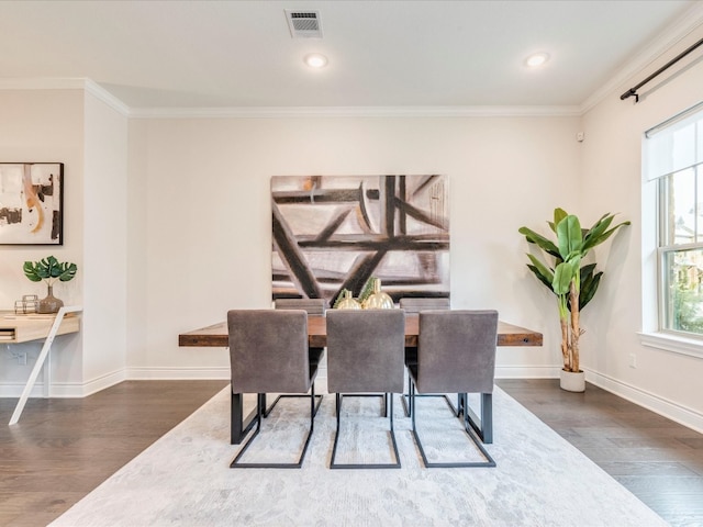 dining room featuring dark hardwood / wood-style flooring and ornamental molding