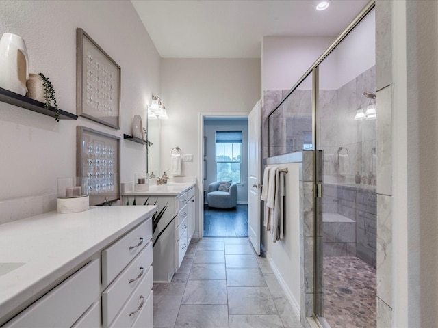 bathroom featuring wood-type flooring, vanity, and a shower with shower door