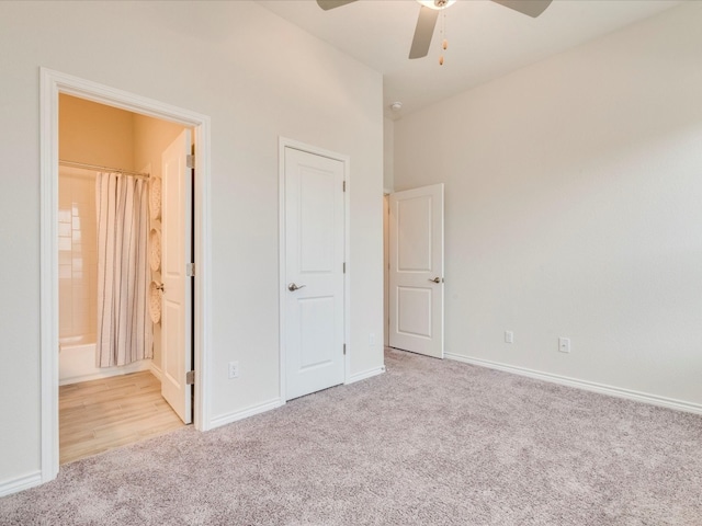 unfurnished bedroom with connected bathroom, light carpet, and ceiling fan