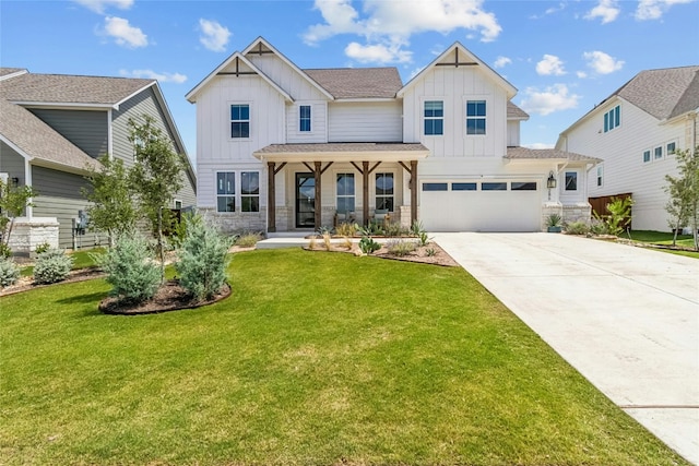 view of front of house with a front yard, covered porch, and a garage