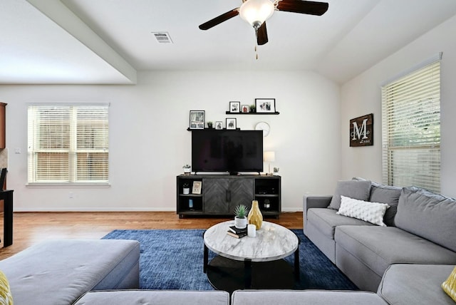 living room with ceiling fan, wood-type flooring, and vaulted ceiling