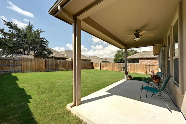 view of yard with a patio area and ceiling fan