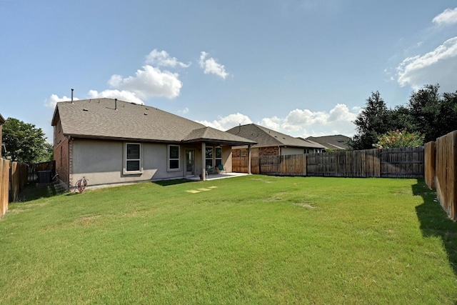 rear view of property with a patio and a lawn